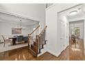 Foyer view to a formal dining room, hardwood floors, and stairs at 8140 High Hampton Chase, Alpharetta, GA 30022