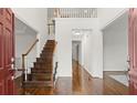 Bright foyer with hardwood floors, staircase, and open view to the upper level at 8140 High Hampton Chase, Alpharetta, GA 30022