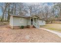 Charming single-story home with a covered front porch and light green painted siding in a wooded area at 2366 Forrest Park Se Rd, Atlanta, GA 30315