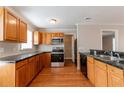 Well-lit kitchen with stainless steel appliances, granite countertops, and wooden cabinets and hardwood floors at 2366 Forrest Park Se Rd, Atlanta, GA 30315