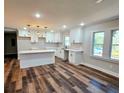 Modern kitchen featuring white shaker cabinets, quartz countertops, and an island at 3284 Boring Rd, Decatur, GA 30034