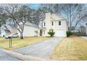 Two-story home with a well-kept lawn, driveway, and manicured landscaping at 5084 Brittany Dr, Stone Mountain, GA 30083