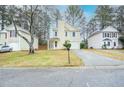 Two-story home with a well-kept lawn, driveway, and manicured landscaping at 5084 Brittany Dr, Stone Mountain, GA 30083