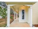 The charming front porch features sleek pillars and recessed lighting at 5084 Brittany Dr, Stone Mountain, GA 30083