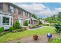 Beautiful landscaped front yard with a brick home, manicured lawn, and an inviting walkway to the front door at 830 Montego Sw Way, Lilburn, GA 30047