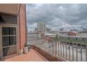 Balcony with brick flooring, metal railing, and city views at 250 Park Avenue West Nw # 903, Atlanta, GA 30313