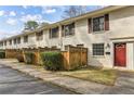 Brick townhouse with red door and a fenced yard at 771 Jordan Ln # F, Decatur, GA 30033