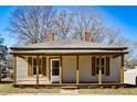 Light beige house with a front porch and shutters at 3 Bay St, Covington, GA 30014