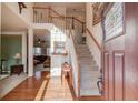 Bright foyer with hardwood floors, staircase, and open view to the living room, showing spacious layout and natural light at 1095 Whitehawk Trl, Lawrenceville, GA 30043