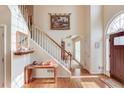 Welcoming foyer with hardwood floors, staircase, and a decorative rug adding warmth to the home's entrance at 1095 Whitehawk Trl, Lawrenceville, GA 30043