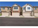 View of townhomes with attached garages and neutral color palettes at 4131 Fulson Dr, Lilburn, GA 30047