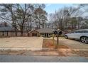 View of the exterior showing the home's architecture, landscaping, and a silver car parked in the driveway at 1119 Summer Brook Rd, Atlanta, GA 30349