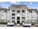 Charming condo building with exterior architectural detail and front parking at 2657 Lenox Ne Rd # 134-2, Atlanta, GA 30324