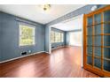 Open living area with hardwood floors and French doors at 241 W Simon Nw Ter, Atlanta, GA 30318