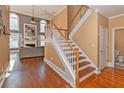 Elegant staircase with hardwood treads and white railings at 1553 Rolling Meadows Dr, Mcdonough, GA 30253