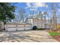 A three-car garage and brick paver driveway lead to a spacious house at 213 Pine Crest Dr, Cumming, GA 30040