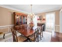 Formal dining room features a chandelier, china cabinet, and large wood table with seating at 3521 Southern Bay Ct, Snellville, GA 30039