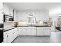 Bright kitchen features white cabinets, granite countertops, and stainless steel appliances at 3521 Southern Bay Ct, Snellville, GA 30039