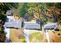 An aerial shot showing three houses with big driveways, complemented by lush greenery and natural light at 681 Fielding Sw Ln, Atlanta, GA 30311
