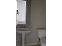 Bathroom featuring pedestal sink and toilet at 11329 Michelle Way, Hampton, GA 30228