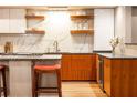 Stylish kitchen with marble backsplash and custom wood cabinets at 3184 Paces Mill Se Rd, Atlanta, GA 30339