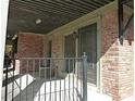 Outdoor patio area featuring brick walls, iron railings, and access to unit C1 at 3091 Colonial Way # C1, Atlanta, GA 30341
