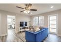 Modern living room featuring a blue sofa and access to a bedroom and balcony at 300 Peachtree Ne St # 3B, Atlanta, GA 30308