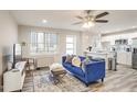 Open concept living room, kitchen and breakfast bar with hardwood floors at 300 Peachtree Ne St # 3B, Atlanta, GA 30308
