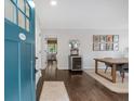 Welcoming entryway featuring hardwood floors, a dining table, and a glimpse of a sunlit room at 1119 Oakdale Se Dr, Smyrna, GA 30080