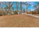 Inviting single-story home with a painted brick facade and a spacious front yard leading to a long driveway at 1119 Oakdale Se Dr, Smyrna, GA 30080