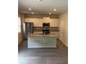 Bright eat-in kitchen with stainless appliances, granite counters, and a center island at 3306 Loblolly Pine Way, Decatur, GA 30034
