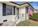 Brick front entry with black accents and American flag at 571 Allgood Ne Rd, Marietta, GA 30060