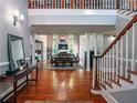 Inviting foyer with hardwood floors, staircase, and a view into the dining and living spaces at 1820 Walker Sw Rd, Conyers, GA 30094