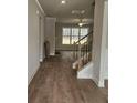 Open foyer with wood floors, stairway with black wrought iron spindles, and great natural light at 3292 Lions Ruby Ln, Atlanta, GA 30349