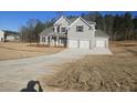 Beautiful home with gray siding, black shutters, large driveway and a two-car garage at 3292 Lions Ruby Ln, Atlanta, GA 30349