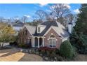 A beautifully landscaped brick home with a well maintained lawn and inviting front porch at 3377 Fielders Pt, Dacula, GA 30019