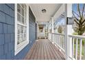 Inviting front porch with wooden flooring and white railings at 601 Formwalt Sw St, Atlanta, GA 30312