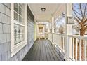 Charming covered front porch with painted wood flooring, white pillars and railings, and classic mailbox at 601 Formwalt Sw St, Atlanta, GA 30312