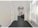 Hallway with freshly painted walls, an arched entryway and dark stained wood floors at 601 Formwalt Sw St, Atlanta, GA 30312