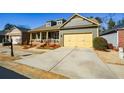 Beautiful home showcasing a cozy front porch, tidy lawn, and a two-car garage for convenient parking at 221 Aster Ct, Canton, GA 30114