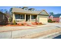 Inviting single-Gathering home boasts a covered front porch, well-maintained landscaping, and a convenient two-car garage at 221 Aster Ct, Canton, GA 30114