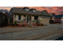 Single-Gathering home with front porch, set against a sunset sky at 221 Aster Ct, Canton, GA 30114