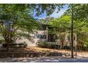 Exterior view of townhome with a brick facade, set against a lush, green landscape at 410 Candler Park Ne Dr # C-1, Atlanta, GA 30307