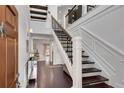 Grand two story foyer featuring dark wood flooring, decorative trim, and elegant staircase with iron railing at 54 Basswood Cir, Atlanta, GA 30328