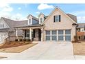 Attractive two-story brick home with a modern garage and well-maintained front lawn at 1611 Saddlegate Dr, Canton, GA 30114