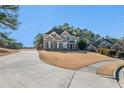 Curved driveway leading to a two-story brick home at 179 Waterstone Pt, Acworth, GA 30101