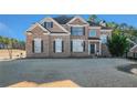 Two-story brick home with landscaping and driveway at 179 Waterstone Pt, Acworth, GA 30101