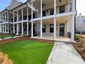 Beautiful townhome exteriors showcase classic columns, manicured lawns, and inviting entrances at 500 Chiswick Cir # 11, Alpharetta, GA 30009
