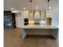 Bright open-concept kitchen featuring a large center island, pendant lights, and modern appliances at 500 Chiswick Cir # 11, Alpharetta, GA 30009