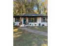 Inviting exterior of a home with white brick, fresh landscaping and an updated stained wood porch at 2358 Tilson Rd, Decatur, GA 30032